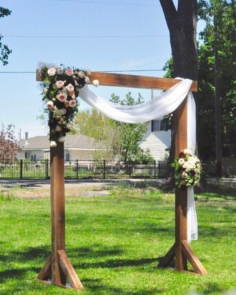 Cedar wedding arch set up for an outdoor ceremony