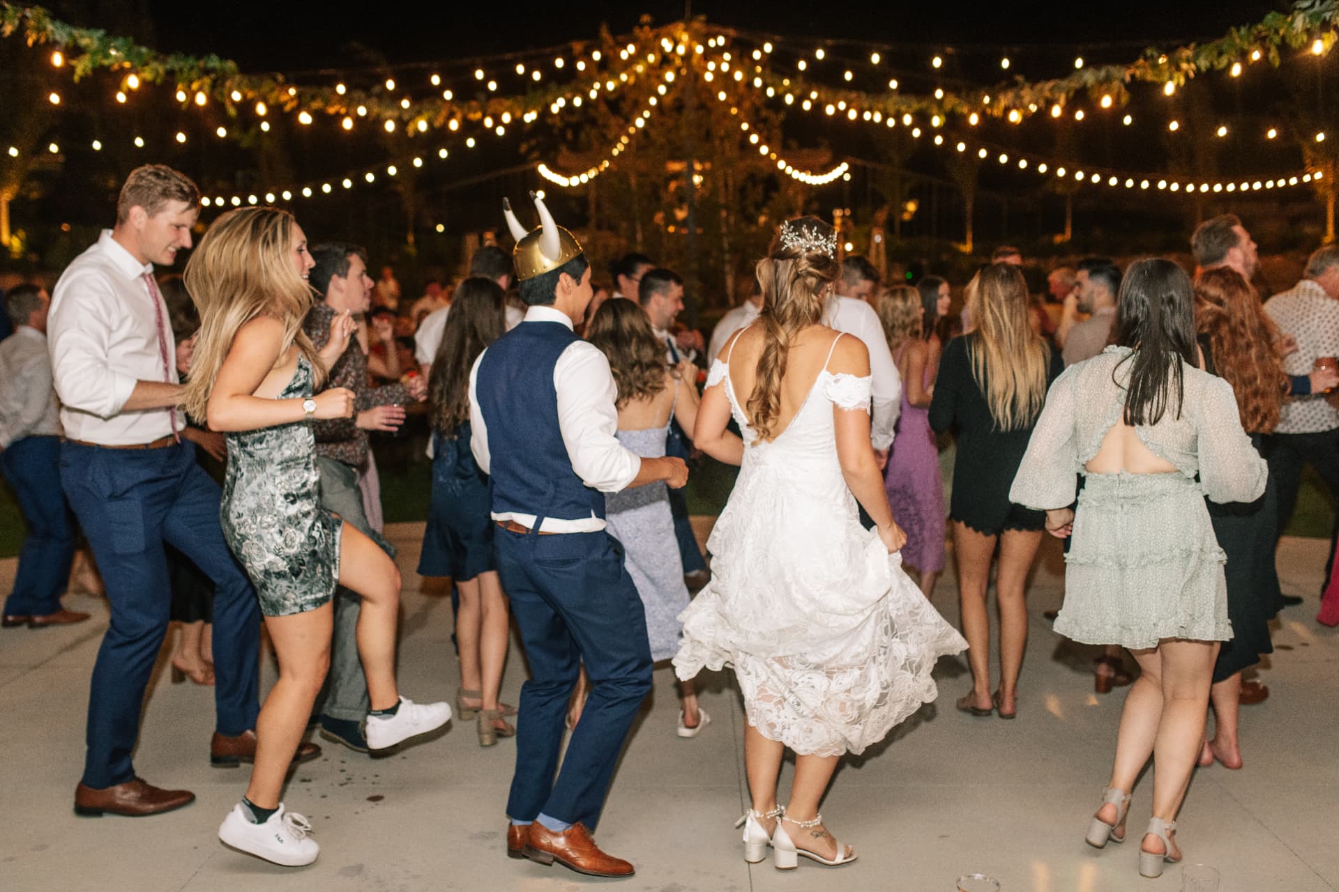 Guests dancing under string lights at a reception at The Venue at Rocky Pond in Chelan, Washington