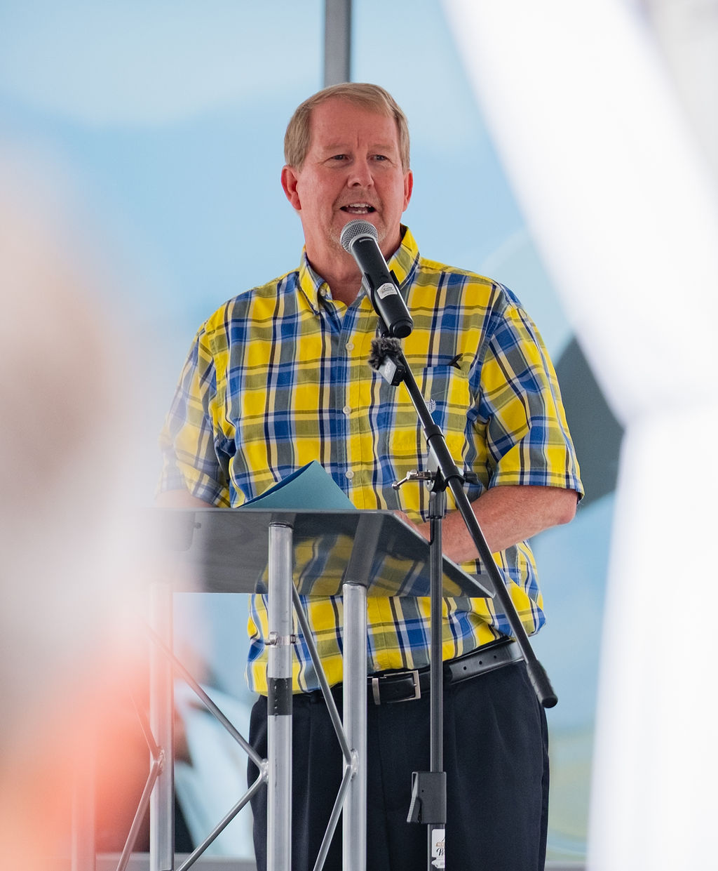 Speaker at a podium under a rented event tent at a corporate ceremony in Eastern Washington