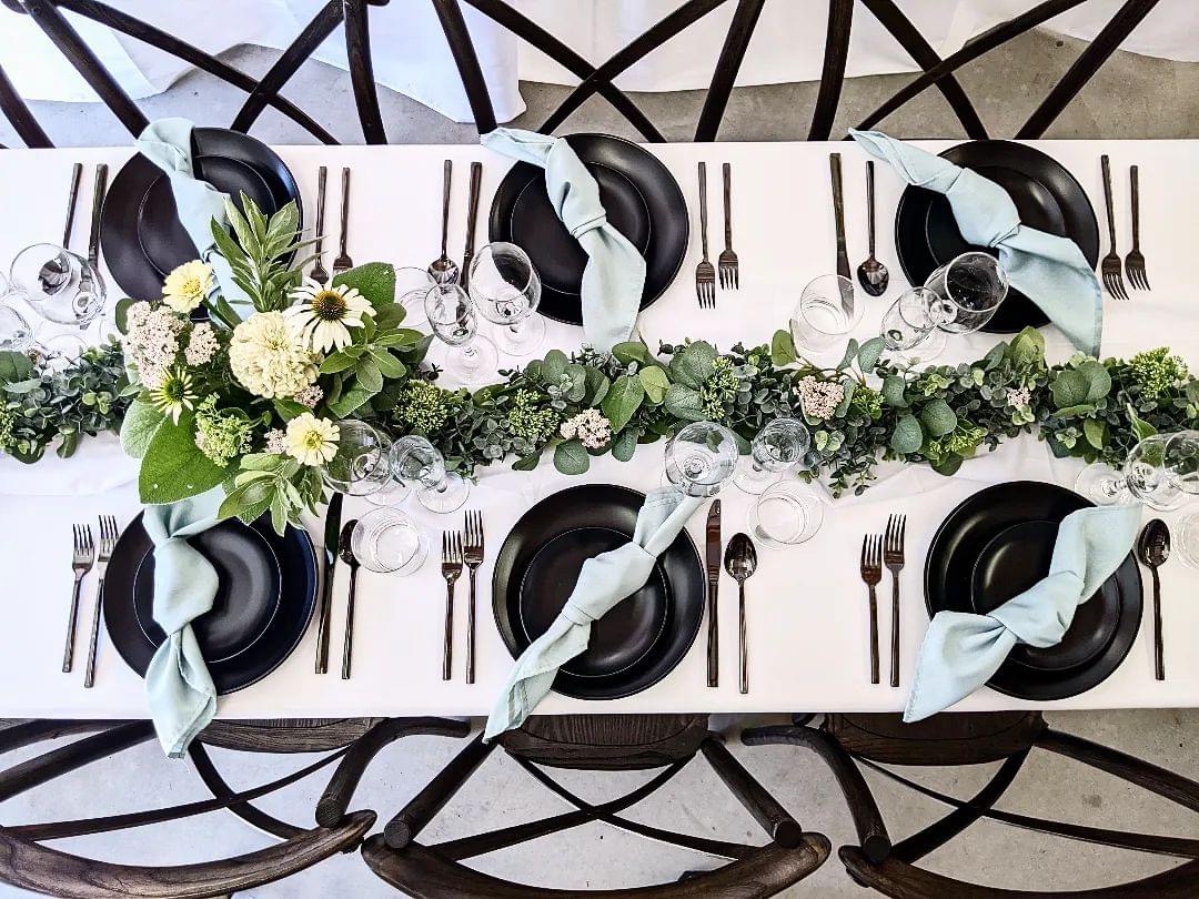 Farm table rental with sage napkins, bronze flatware and glassware rentals in Eastern Washington