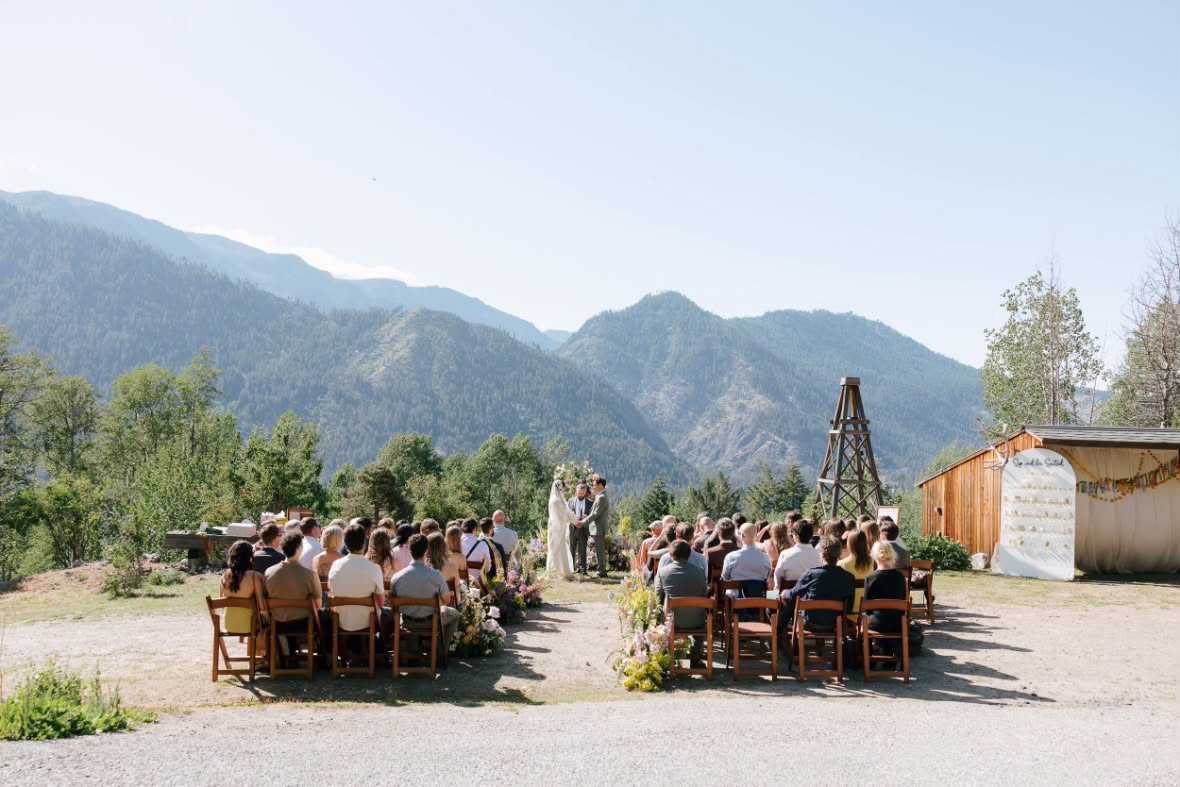 White resin chair rentals set for a mountain wedding ceremony in Washington