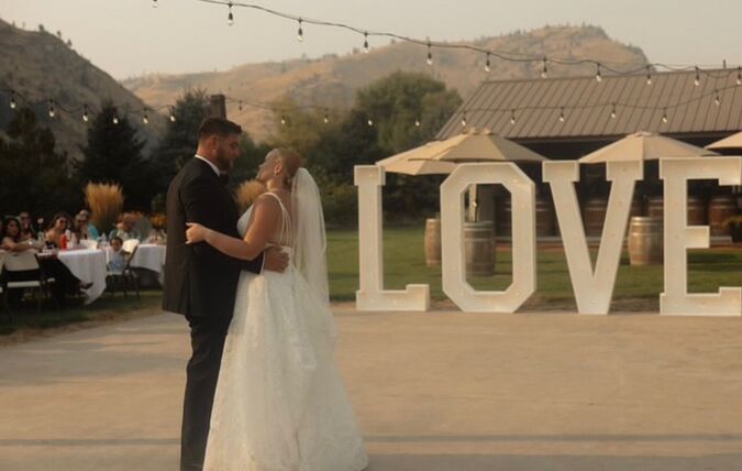 Six foot lit LOVE marquee letters at a wedding reception