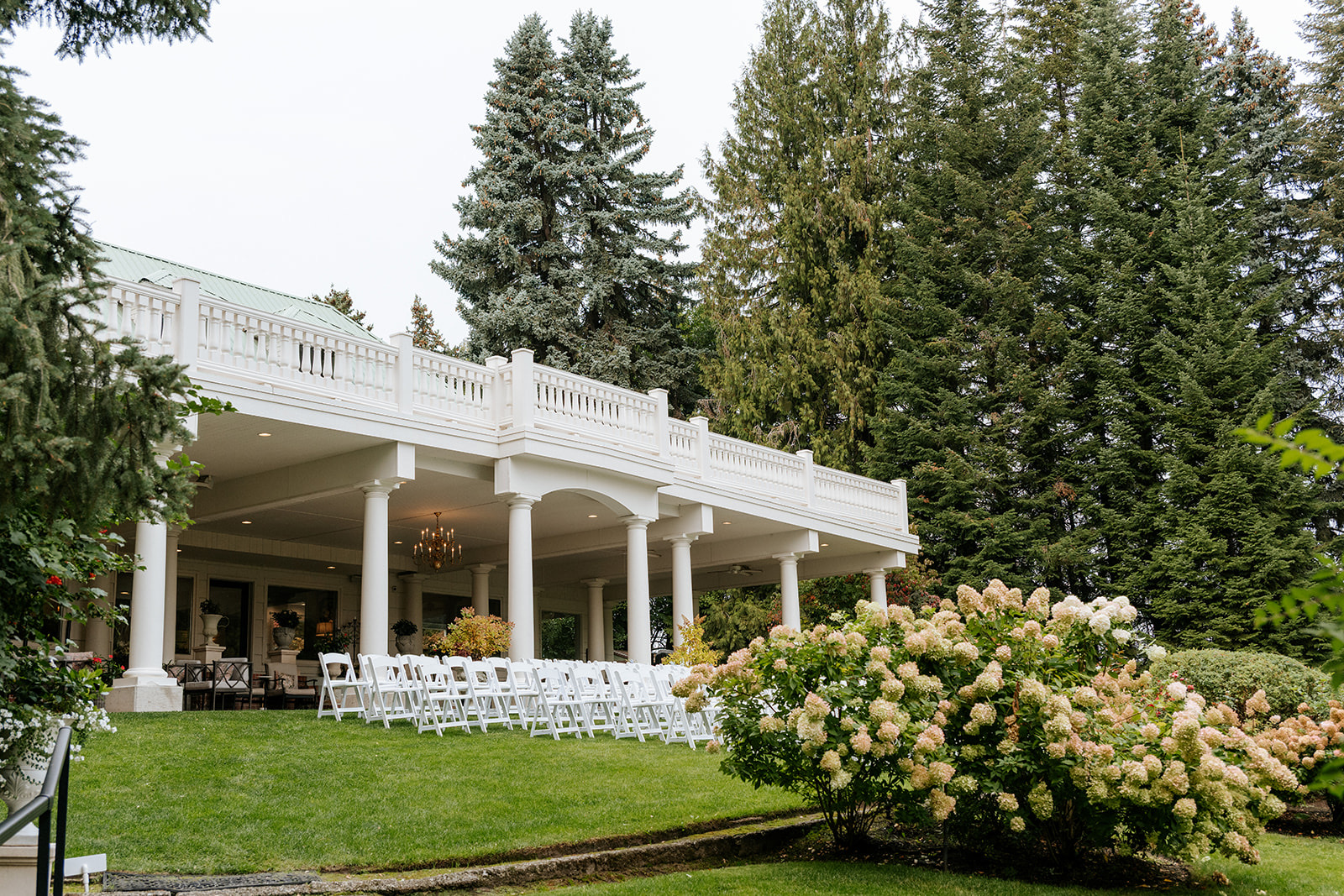 White resin ceremony chair rentals on the lawn at Beecher Hill House near Wenatchee, Washington
