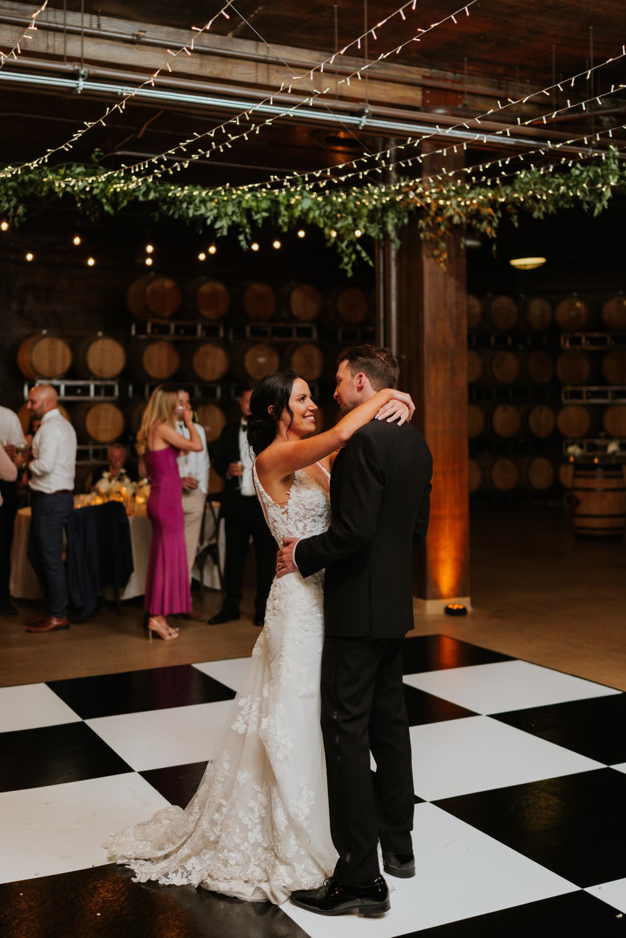 Wedding guests on a checkered dance floor rental at Swiftwater Cellars in Cle Elum, Washington