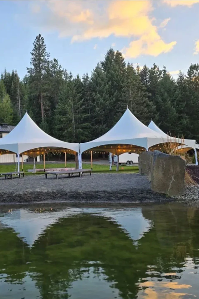 White event tent set up on a property in Eastern Washington at dusk
