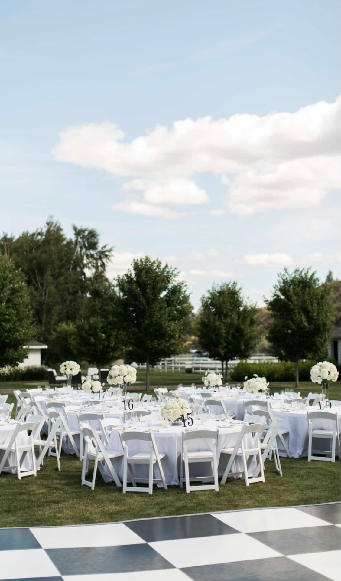 Lawn reception with round table rentals and a dance floor at an Eastern Washington wedding