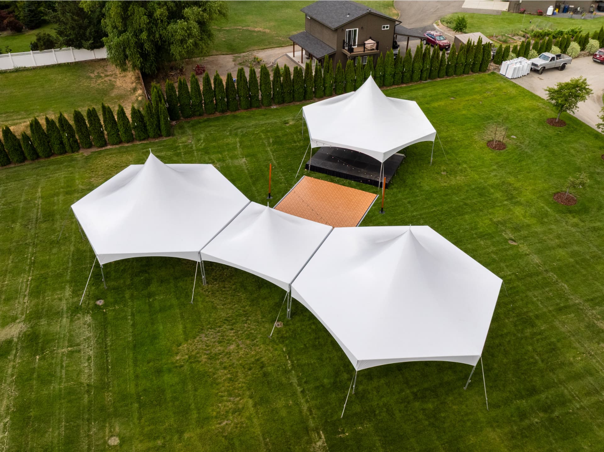 Tented reception with lighting and table rentals at an Eastern Washington wedding