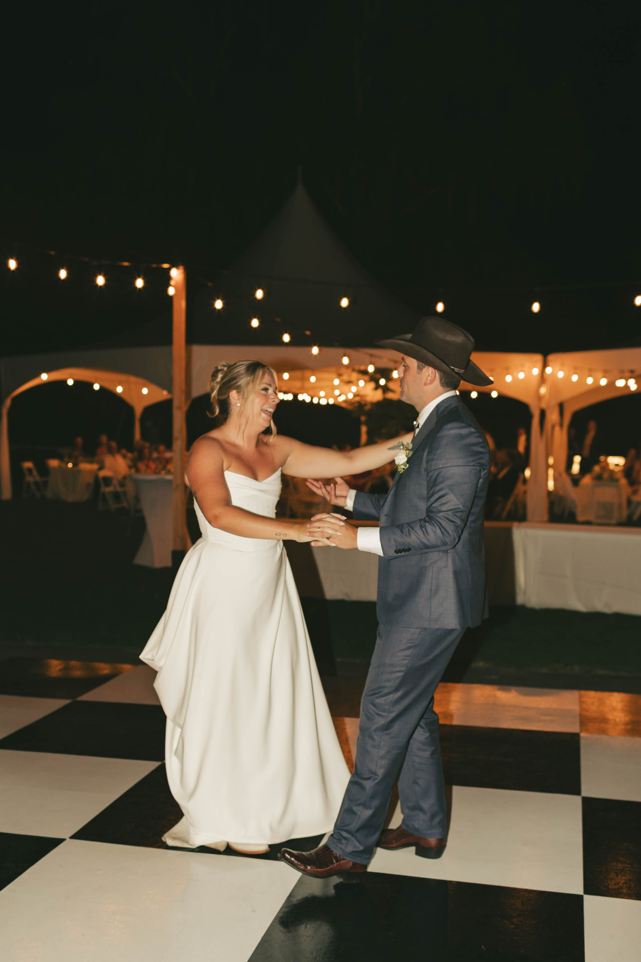 First dance on a black and white checkered dance floor rental at an Eastern Washington wedding